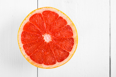 Fresh Red Grapefruit Slice On White Tableの写真素材