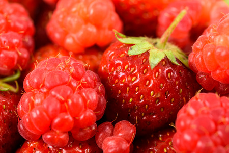 Raspberry And Strawberry Pile In Fruit Market