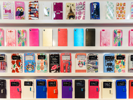 VALENCIA, SPAIN - JULY 23, 2016: Colorful iPhone And Samsung Phone Cases For Sale In Mobile Phones Stores.のeditorial素材