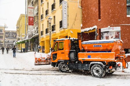 BUCHAREST, ROMANIA - JANUARY 06, 2017: Worker Snow Plow Truck During Heavy Snow Storm In Downtown...