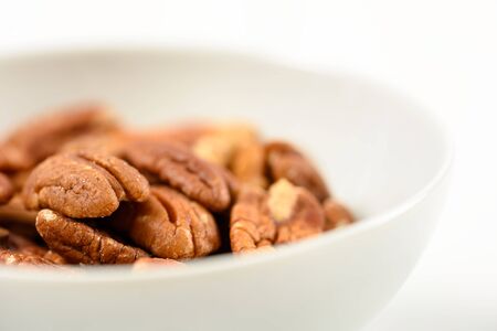 Pecan Nuts In White Bowl On Tableの写真素材