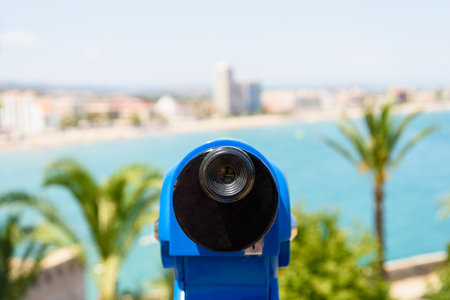 Blue Coin Operated Telescope Of Panoramic Tropical City And Ocean Viewの写真素材