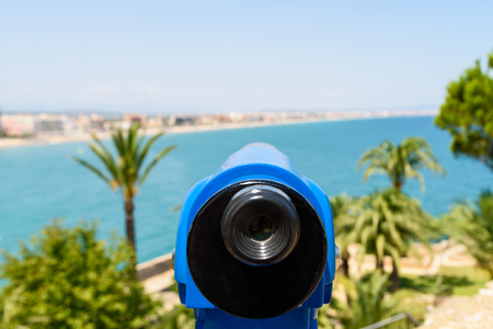 Blue Coin Operated Telescope Of Panoramic Tropical City And Ocean Viewの写真素材