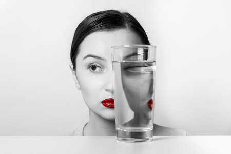Woman Face Distortion In Glass Of Waterの写真素材