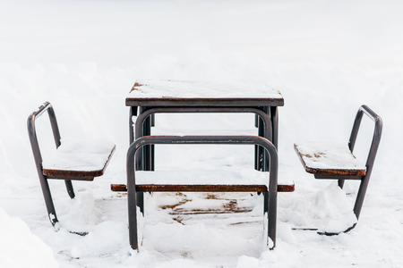 Table And Chairs Covered In Winter Snowの写真素材