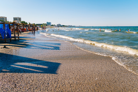 MAMAIA, ROMANIA - JULY 14, 2017: People Having Fun In Water And Relaxing In Mamaia Beach Resort At The Black Sea In Romania.のeditorial素材