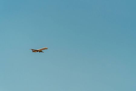 Airplane On Clear Blue Summer Skyの写真素材