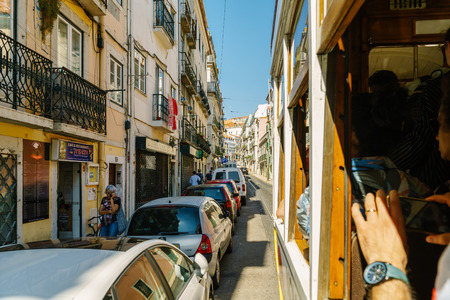 LISBON, PORTUGAL - AUGUST 09, 2017: Tourists Travel By Tram 28 In Downtown Lisbon City.のeditorial素材