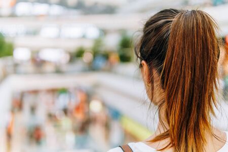 Young Woman Exploring Modern Shopping Mall