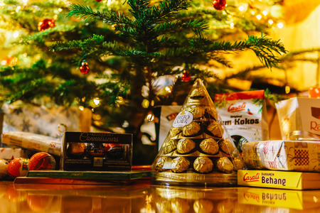 BUCHAREST, ROMANIA - DECEMBER 24, 2017: Presents And Chocolate Candies Waiting To Be Opened Under Christmas Treeのeditorial素材