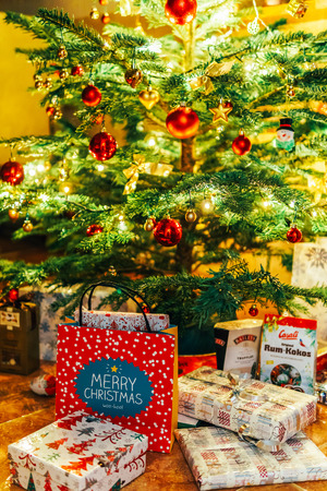 BUCHAREST, ROMANIA - DECEMBER 24, 2017: Presents And Chocolate Candies Waiting To Be Opened Under Christmas Treeのeditorial素材