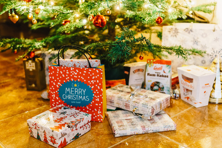 BUCHAREST, ROMANIA - DECEMBER 24, 2017: Presents And Chocolate Candies Waiting To Be Opened Under Christmas Treeのeditorial素材