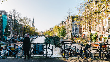 AMSTERDAM, NETHERLANDS - NOVEMBER 08, 2017: Bicycles and Dutch Houses On Amsterdam Canal In Autumnのeditorial素材