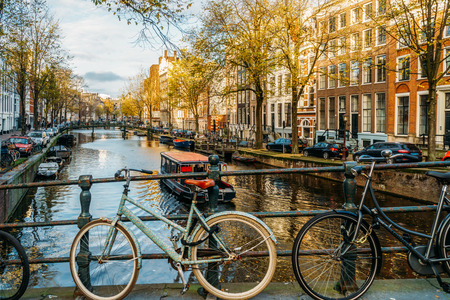 AMSTERDAM, NETHERLANDS - NOVEMBER 13, 2017: Bicycles and Dutch Houses On Amsterdam Canal In Autumnのeditorial素材