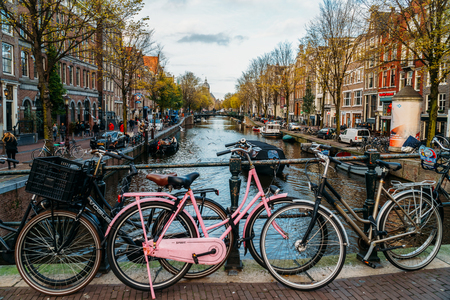 AMSTERDAM, NETHERLANDS - NOVEMBER 13, 2017: Bicycles and Dutch Houses On Amsterdam Canal In Autumnのeditorial素材