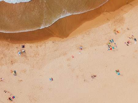 Aerial View From Flying Drone Of People Crowd Relaxing On Algarve Beach In Portugal