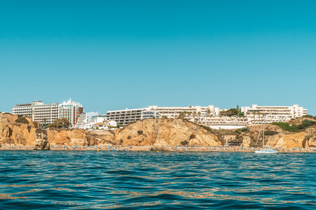 Tourists Having Fun In Water, Relaxing And Sunbathing At Lagos Beach In Algarve, Portugalの写真素材