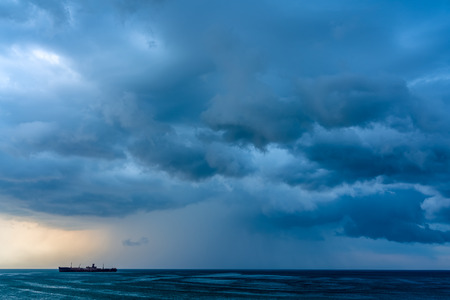 Storm Clouds Gathering Over Shipwreck Oceanの写真素材