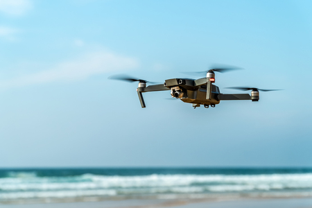 UAV Quadcopter And Digital Camera Flying On Beach