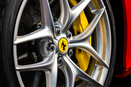BUCHAREST, ROMANIA - OCTOBER 19, 2018: Ferrari Logo Sign Closeup View On Car Alloy Wheel With Yellow Brake Calipers And Drilled Disk Brakeのeditorial素材
