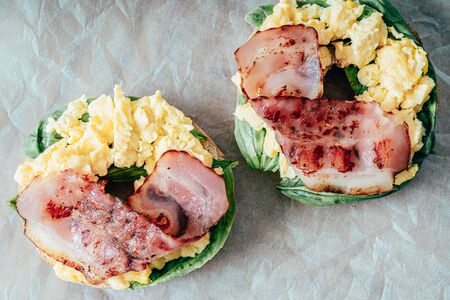 Breakfast Bagel With Scrambled Eggs, Spinach And Baconの写真素材