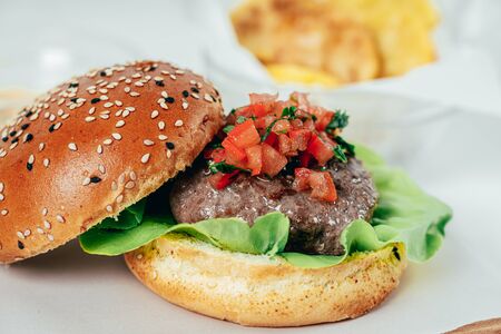 Beef Burger With Lettuce Salad, Tomatoes And Chipsの写真素材