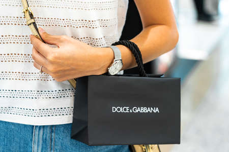 BARCELONA, SPAIN - JUNE 04, 2019: Woman buying Dolce & Gabbana clothes and accessories in luxury shopping mallのeditorial素材