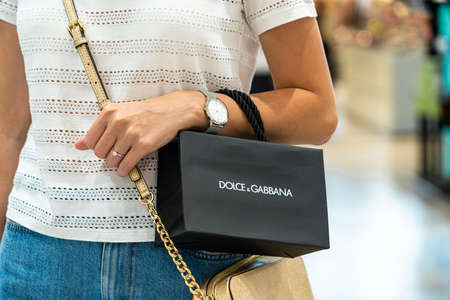 BARCELONA, SPAIN - JUNE 04, 2019: Woman buying Dolce & Gabbana clothes and accessories in luxury shopping mallのeditorial素材