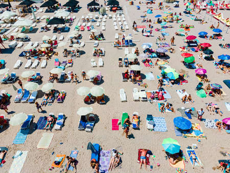Aerial View Of People And Colorful Umbrellas On Ocean Seaside Beach In Summerの写真素材