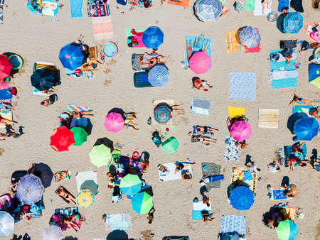 Aerial View Of People And Colorful Umbrellas On Ocean Seaside Beach In Summerの写真素材