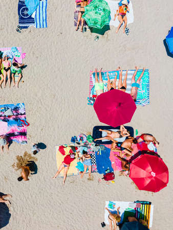 Aerial View Of People And Colorful Umbrellas On Ocean Seaside Beach In Summerの写真素材