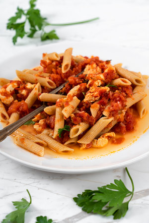 Pasta Penne, Tomato Sauce and Salmon on White Marble Table Backgroundの写真素材