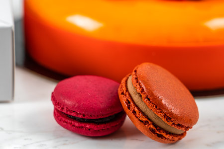 Orange, Mango, Raspberry Fruit Anniversary Birthday Cake and Colorful Homemade French Macaronsの写真素材