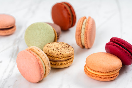 Colorful Fruity Macarons Flat Lay and Top View on White Marble Tableの写真素材