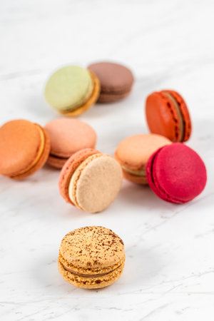 Colorful Fruity Macarons Flat Lay and Top View on White Marble Tableの写真素材