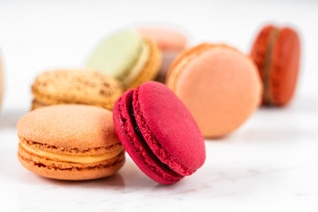 Colorful Fruity Macarons Flat Lay and Top View on White Marble Tableの写真素材