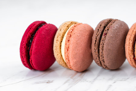 Colorful Fruity Macarons Flat Lay and Top View on White Marble Tableの写真素材