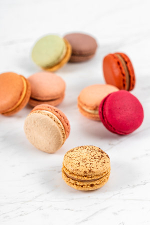 Colorful Fruity Macarons Flat Lay and Top View on White Marble Tableの写真素材
