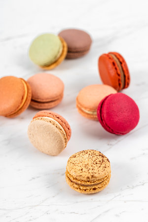 Colorful Fruity Macarons Flat Lay and Top View on White Marble Tableの写真素材