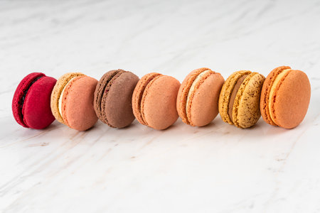 Colorful Fruity Macarons Flat Lay and Top View on White Marble Tableの写真素材