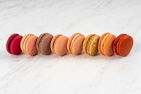 Colorful Fruity Macarons Flat Lay and Top View on White Marble Tableの写真素材