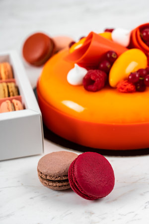 Orange, Mango, Raspberry Fruit Anniversary Birthday Cake and Colorful Homemade French Macaronsの写真素材