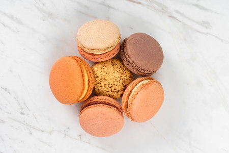 Colorful Fruity Macarons Flat Lay and Top View on White Marble Tableの写真素材