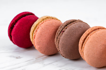 Colorful Fruity Macarons Flat Lay and Top View on White Marble Tableの写真素材