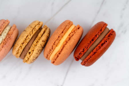 Colorful Fruity Macarons Flat Lay and Top View on White Marble Tableの写真素材