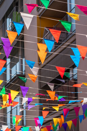 Spanish Catholic Holiday Party Decorations With Colored Flags In Barcelona, Spainの写真素材