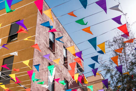 Spanish Catholic Holiday Party Decorations With Colored Flags In Barcelona, Spainの写真素材