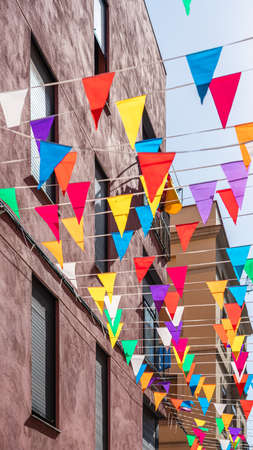 Spanish Catholic Holiday Party Decorations With Colored Flags In Barcelona, Spainの写真素材