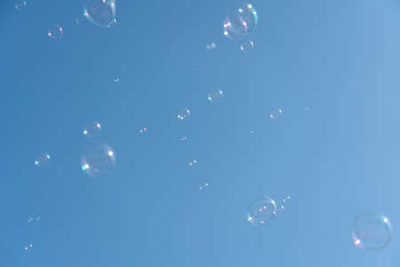 Soap Bubbles Floating On Blue Skyの写真素材