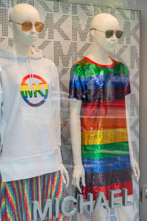 BARCELONA, SPAIN - JUNE 10, 2019: Michael Kors Store ready for the annual gay pride parade. Rainbow clothes decorated mannequins in shop window display.のeditorial素材